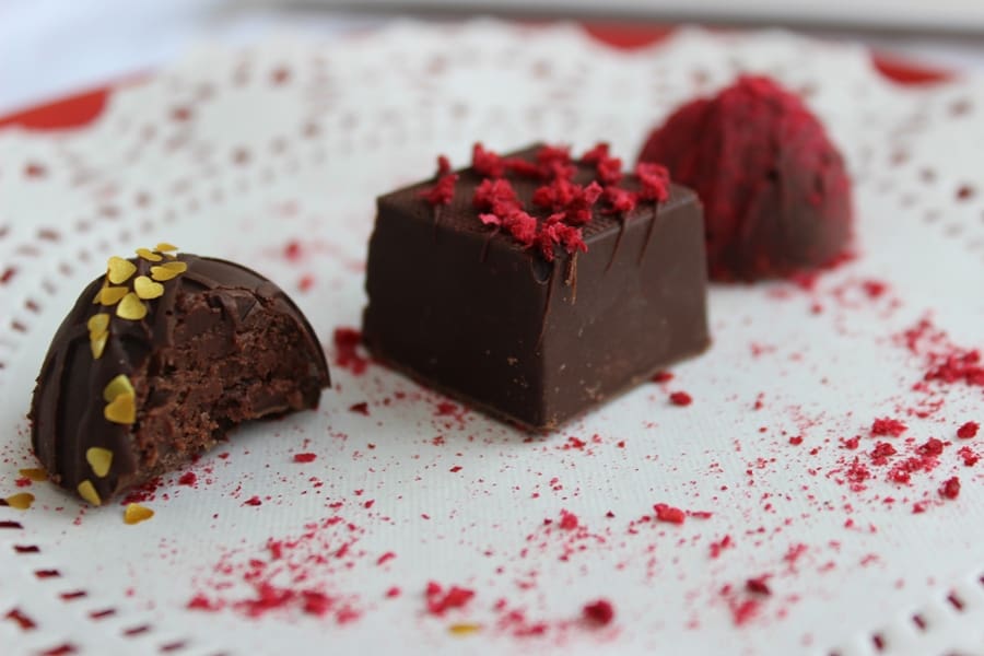 Easy dessert for two? You found it! These keto truffles are as easy as they are beautiful and tasty. Raspberry ganache is covered in sugar free chocolate and then decorated with vibrant raspberry. Yum! #ketotruffles #ketochocolateraspberrytruffles #raspberrytruffles #ketocandy #ketotruffles #lowcarbchocolates #lowcarbtruffles #keenforketo