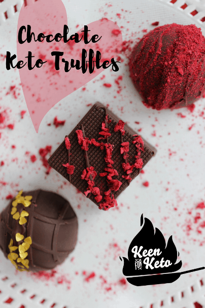 Pin this now for Valentine's Day! These keto truffles will rock your Valentine's world! Sugar free chocolate covering a creamy chocolate raspberry center and decorated with freeze-dried raspberries and dainty edible gold hearts. Great dessert for the keto diet! #keto #ketovalentinesday #ketocandy