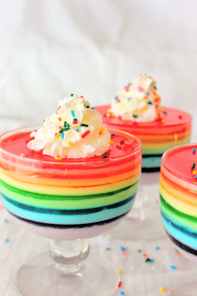 Keto Rainbow Sugar Free Jello Cups with whipped cream and sprinkles